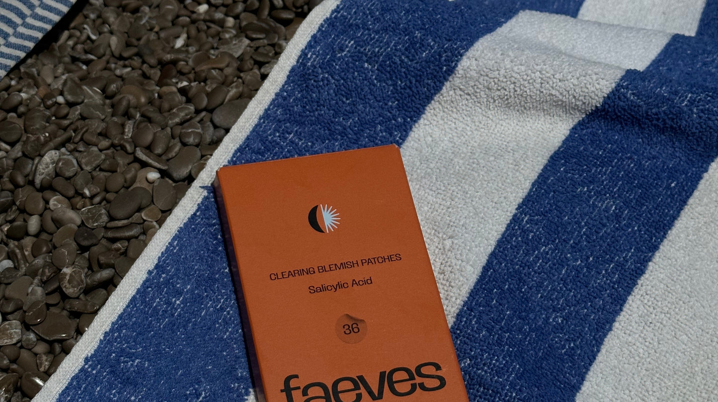 Faeves Clearing Blemish Patches resting on a striped beach towel, perfect for skincare on the go during a beach day.