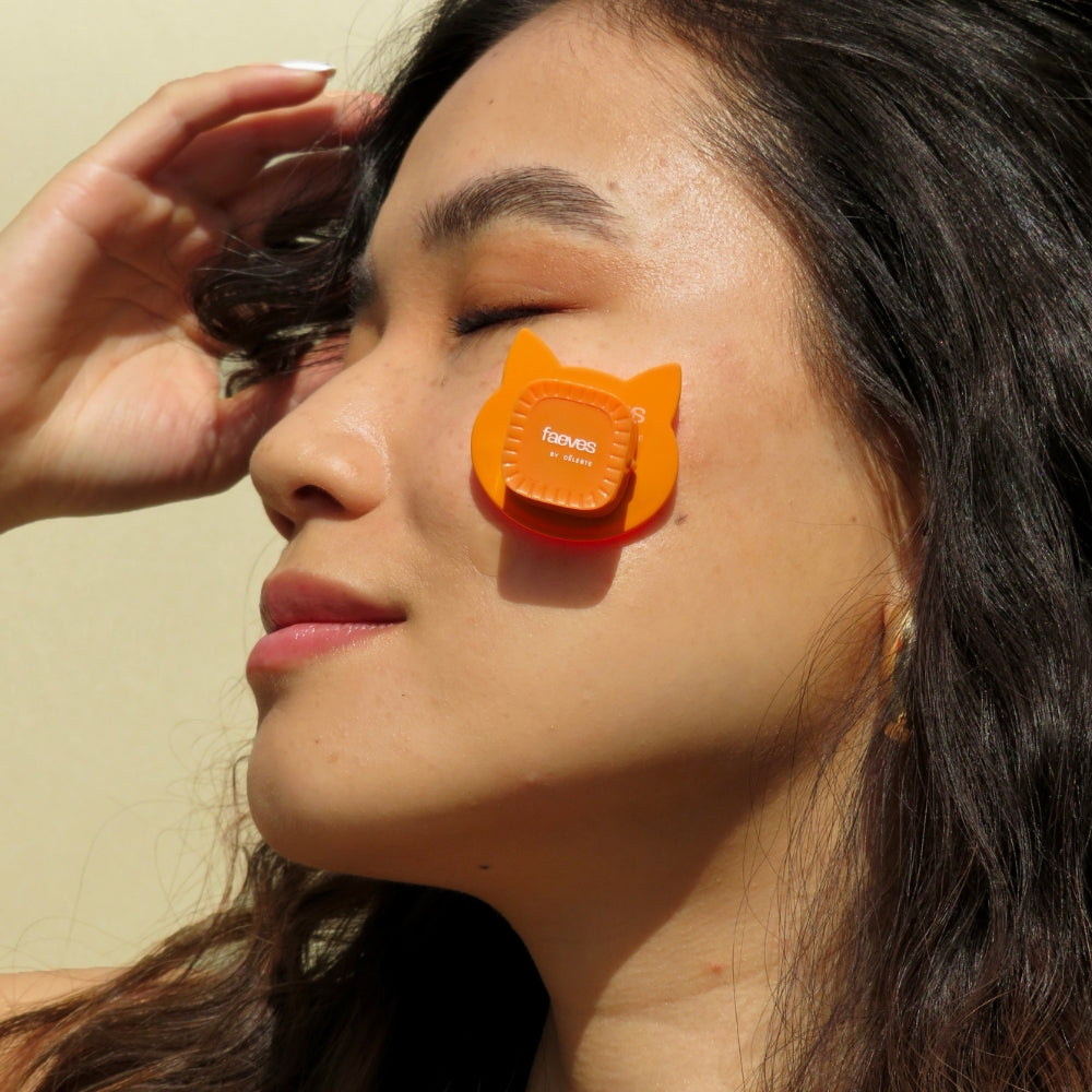 
                  
                    Side profile of a woman relaxing with the Faeves LED Patch on her cheek, showcasing the product's design and soothing skincare treatment."
                  
                